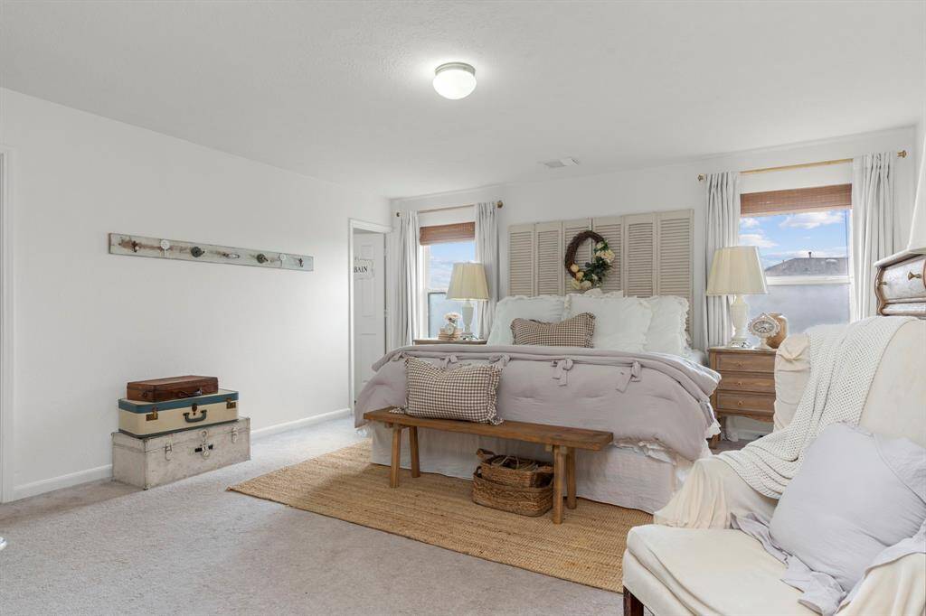 The spacious Primary bedroom offers a retreat with its ensuite full bath, closet space and big windows