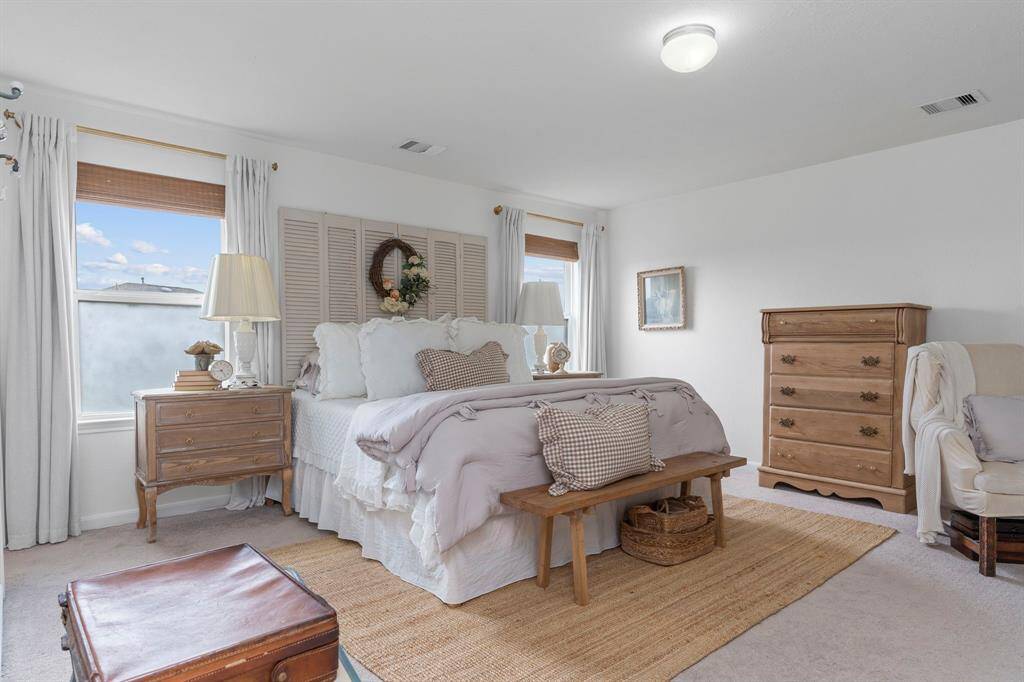 The spacious Primary bedroom offers a retreat with its ensuite full bath, closet space and big windows