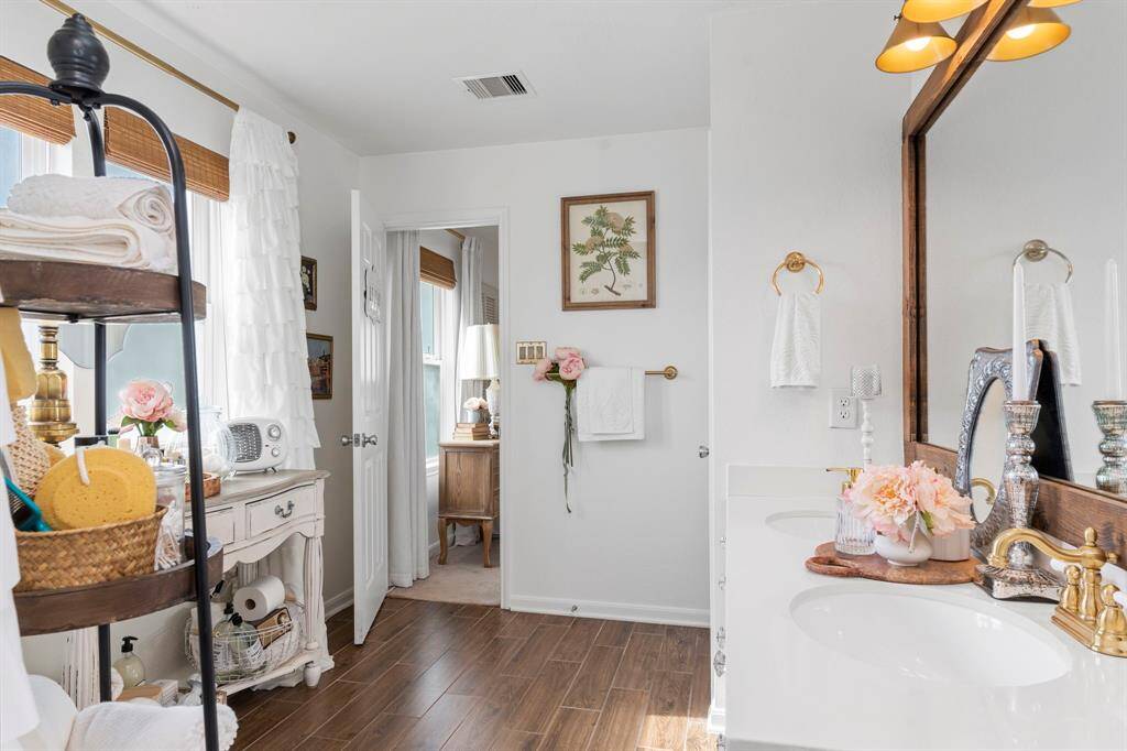 Primary bathroom with dual vanity and a tub/shower combo