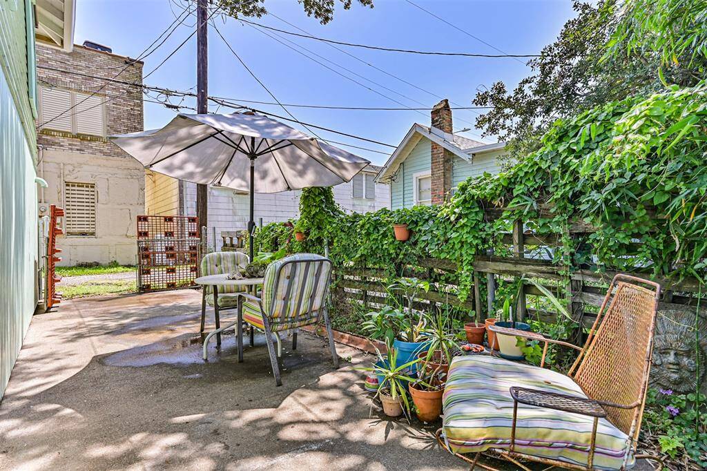Serene paved patio surrounded by lush greenery, perfect for relaxation and outdoor gatherings.