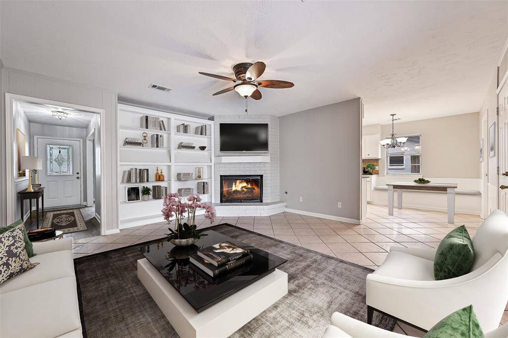 Large family room with fireplace and built ins ~