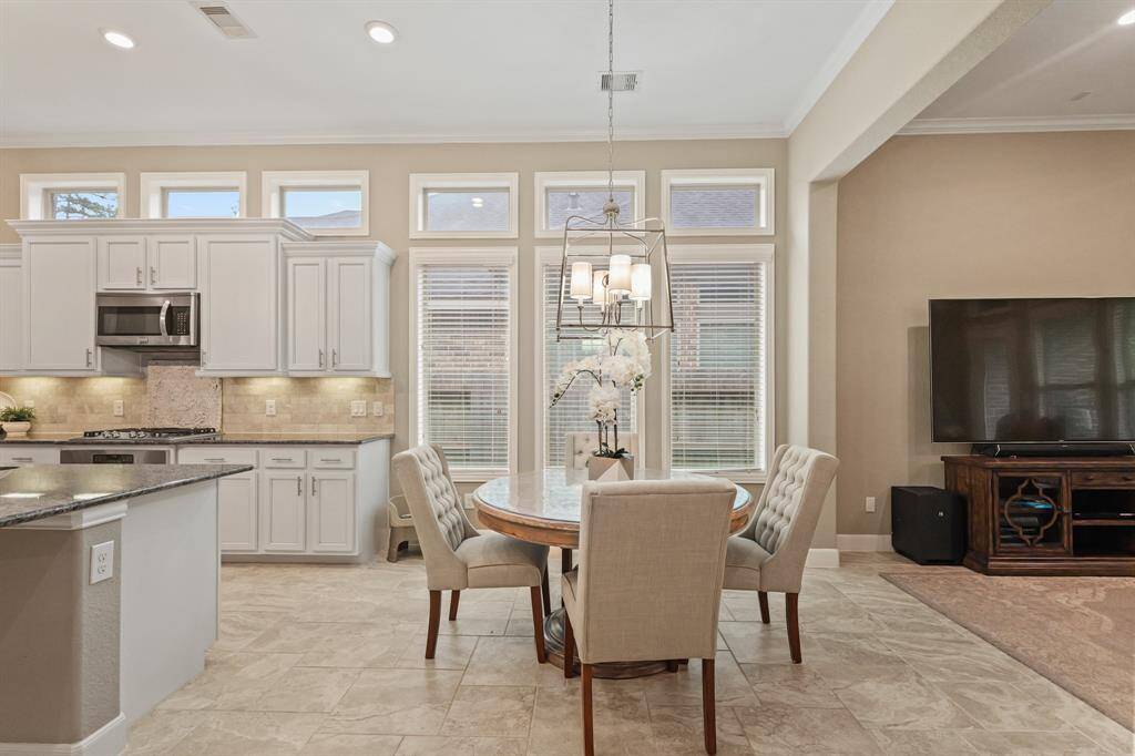 The dining is conveniently open to the living and kitchen, perfect for entertaining.