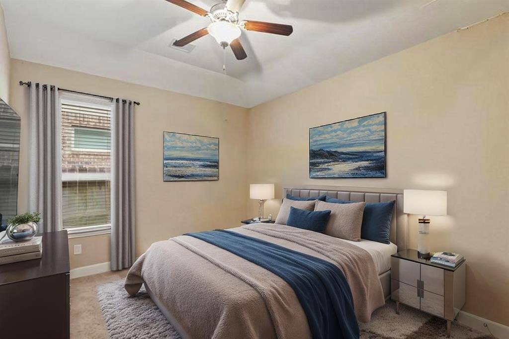 Virtually Staged: Secondary bedroom with carpet floors, a window with privacy blinds, and a ceiling fan.