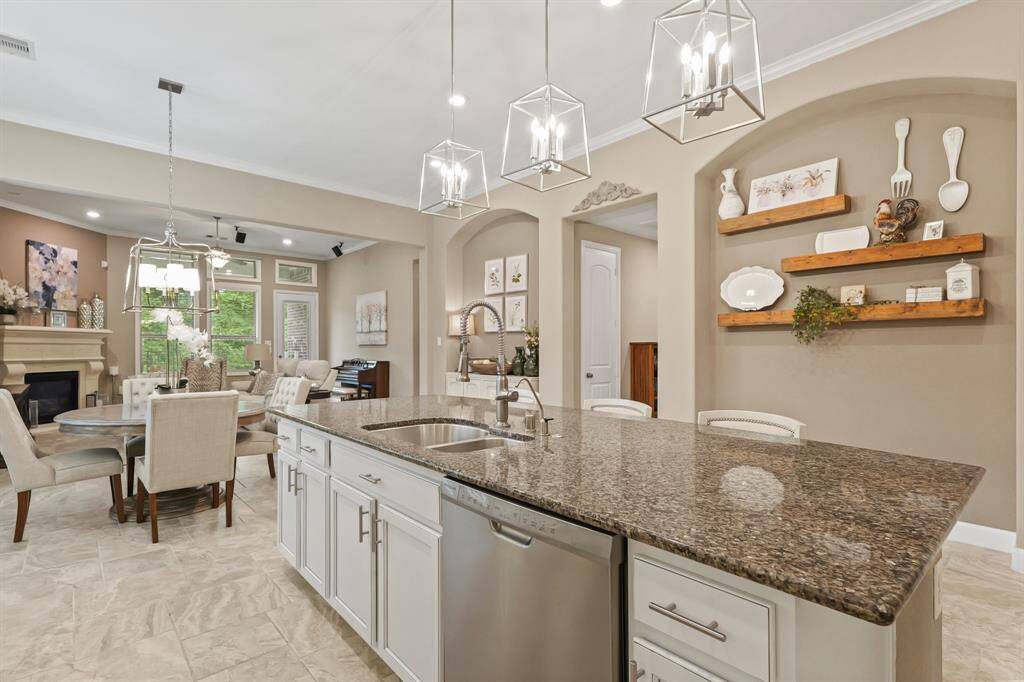 Whip up a meal for your family, friends, and guests while still being a part of all of the action. This open plan has crown molding details too.