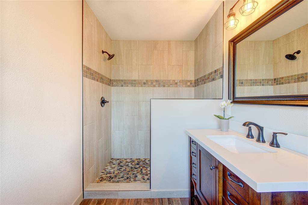 Enjoy your stunning ensuite bathroom with its beautifully tiled shower with pebble-like floor and farmhouse vanity. All new and never been used!