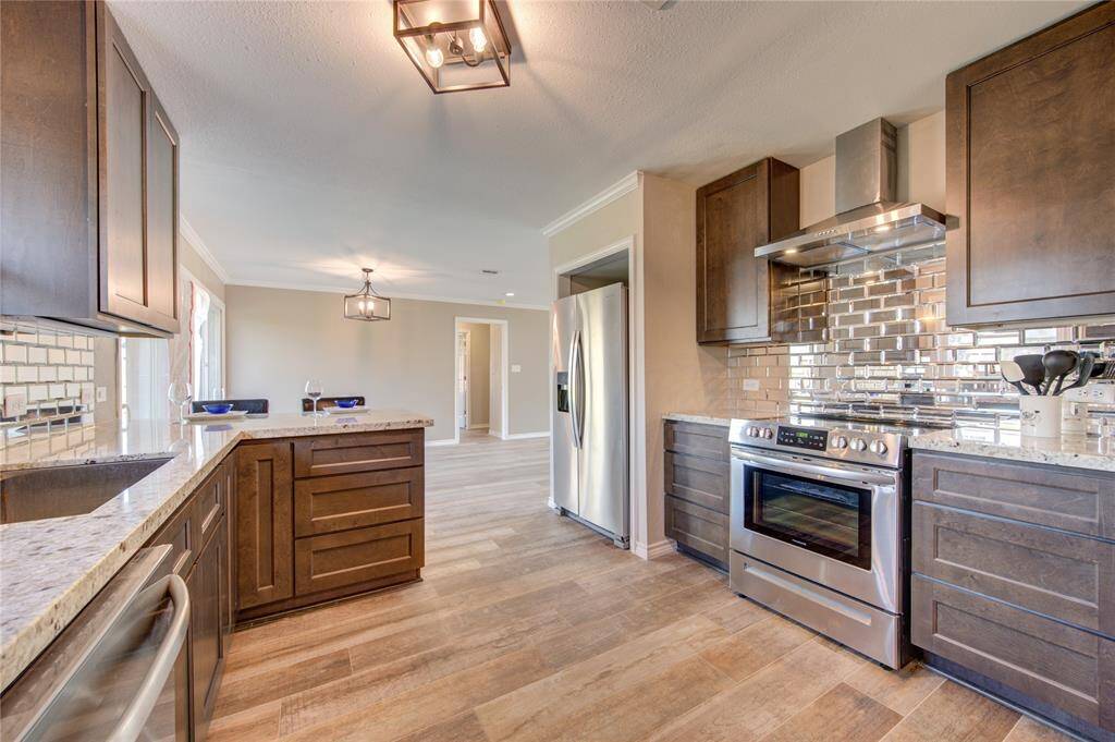 You will love cooking in this NEW GOURMET kitchen with GRANITE COUNTER TOPS, sleek mirrored back-splash, STAINLESS-STEEL APPLIANCES, tons of storage, and a beautiful high powered STAINLESS VENT HOOD. Cleaning up will be a breeze with this STAINLESS FARMHOUSE SINK!