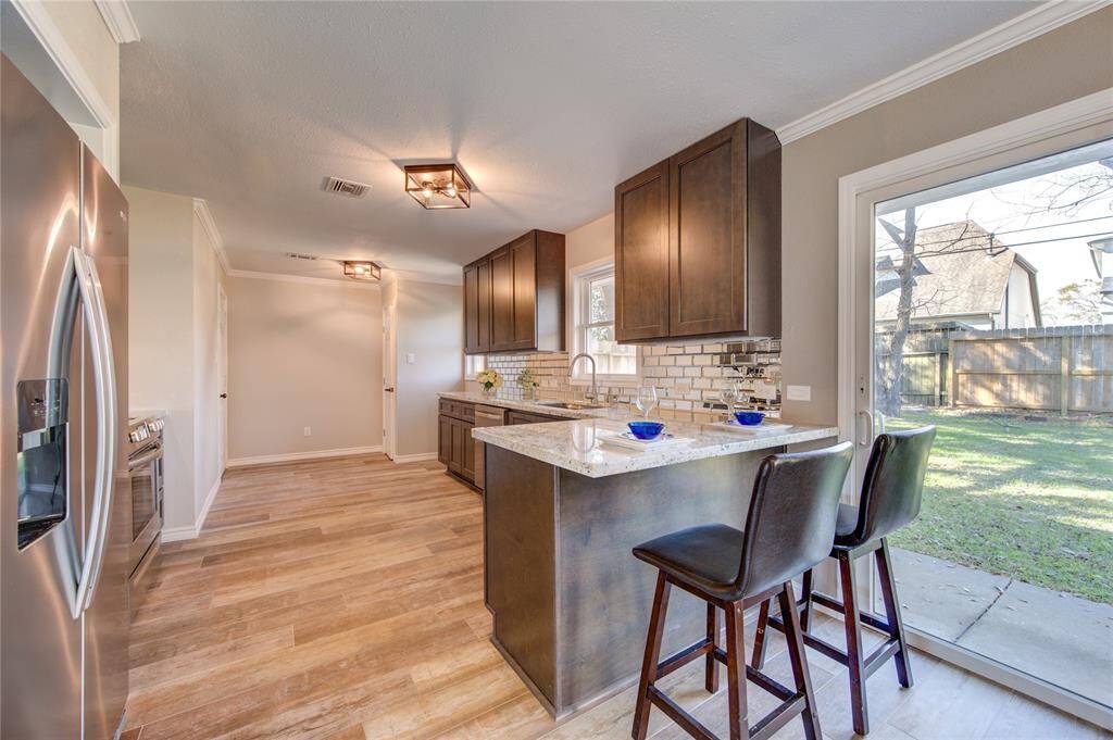 Enjoy your casual meals at this convenient BREAKFAST BAR as you gaze out at the huge backyard and into your stunning kitchen! There's even a pantry at the back of the kitchen opposite the door to your attached garage where you can conveniently do your laundry.