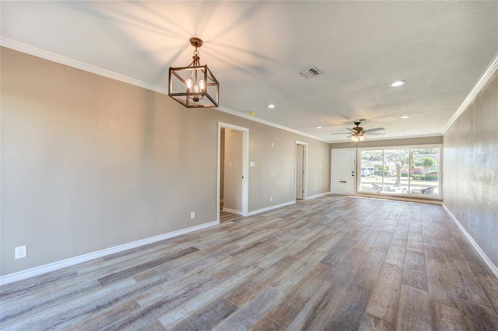 HUGE OPEN FLOORPLAN with dining room/living room combo which is FLOODED WITH NATURAL LIGHT with floor to ceiling windows at the front of the house as well as the back of the house! These doors conveniently lead to your 3 bedrooms and 2 bathrooms, which can be closed off from the entertainment area.