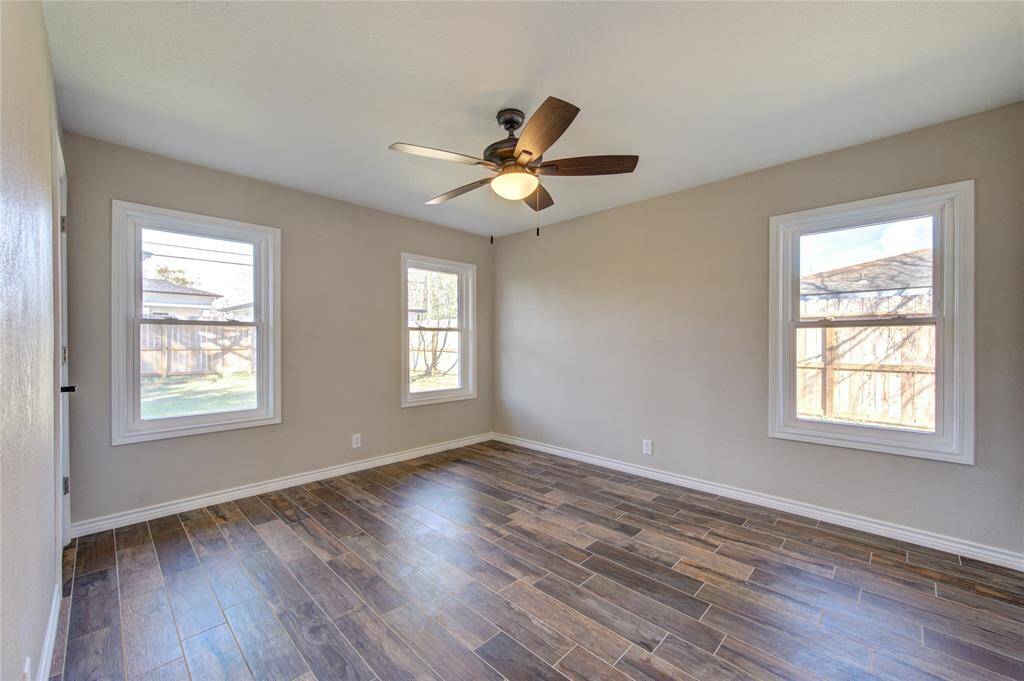 This bright and airy primary bedroom is tucked at the back of the house looking out onto your beautiful fully fenced yard. With ceiling fans in all bedrooms, it will be easy to stay cool. (Landlord with install window treatments soon.)