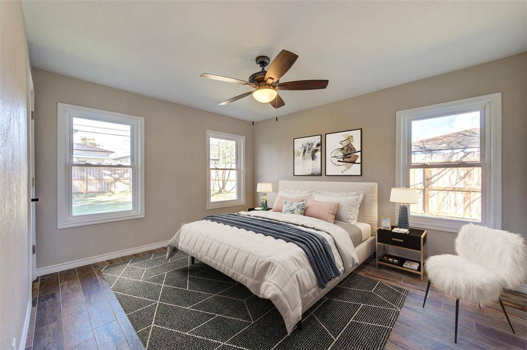 This virtually staged photo shows how fabulous your primary bedroom can look as you enjoy your bright and airy cozy oasis.