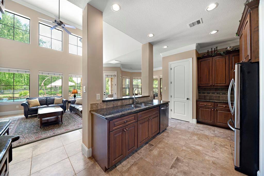 Experience the convenience of a walk-in pantry perfectly integrated into this kitchen's elegant design.