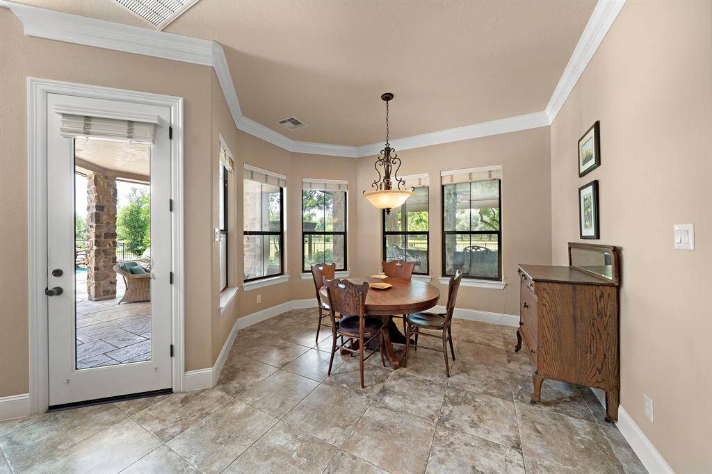 Well-appointed breakfast nook with picturesque views of the outdoor kitchen and patio.