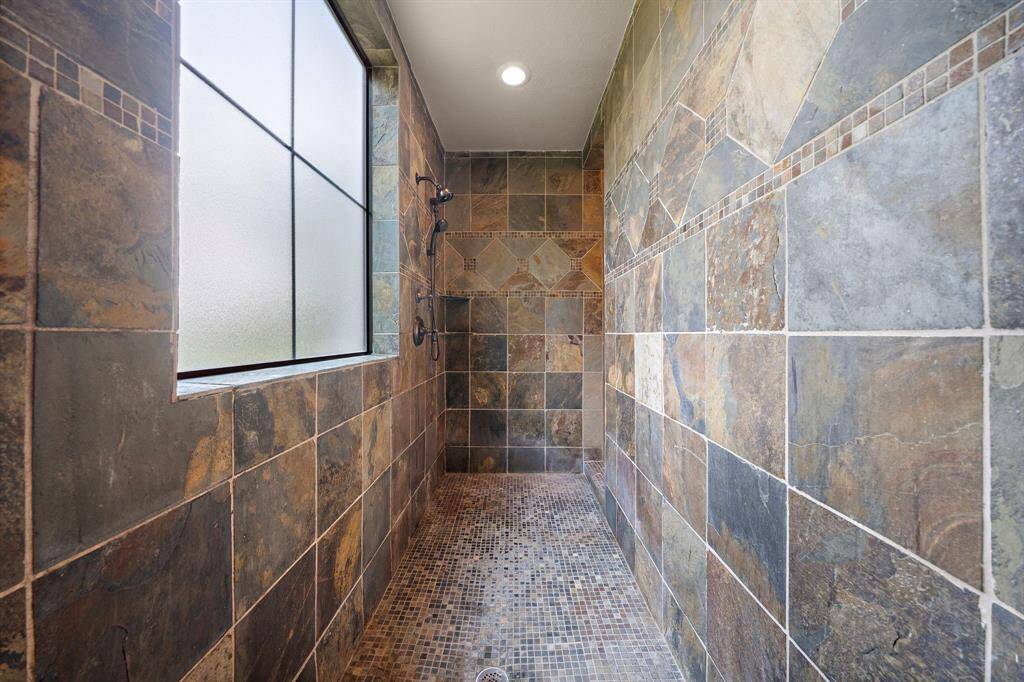 This photo highlights the dual sinks, built-in cabinets, and vanity.  The door in the picture leads to the primary closet.  See floorplan for dimensions.