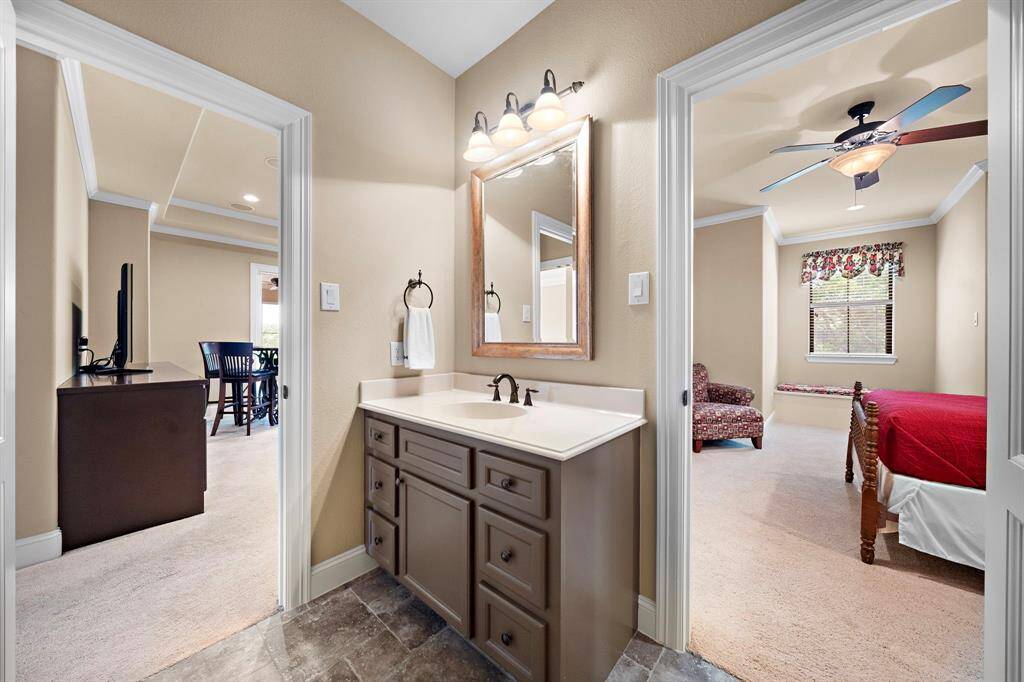 This bathroom vanity with ample storage allows access for upstairs secondary bedroom 3 as well as access for guest from the upstairs gameroom.