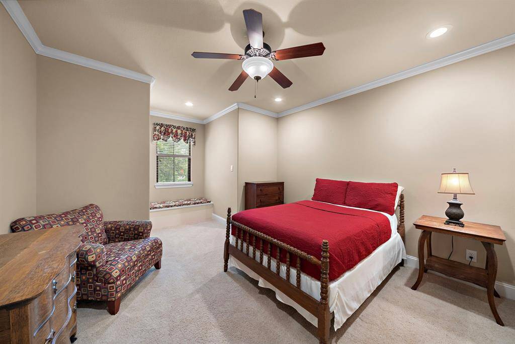 Charming upstairs secondary bedroom 3 with cozy sitting area and spacious walk-in closet.