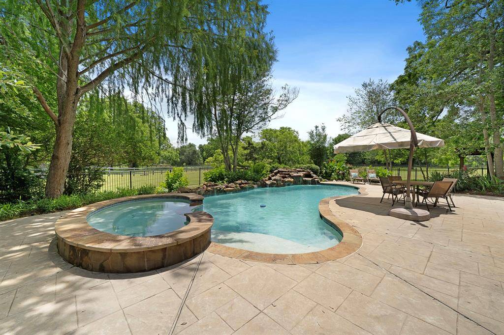 This space has been beautifully framed by lush landscaping.