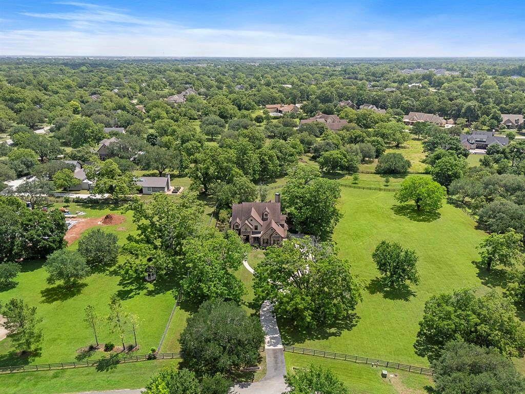 This photo highlights the property along with the addtional acreage for sale to the right of the home.