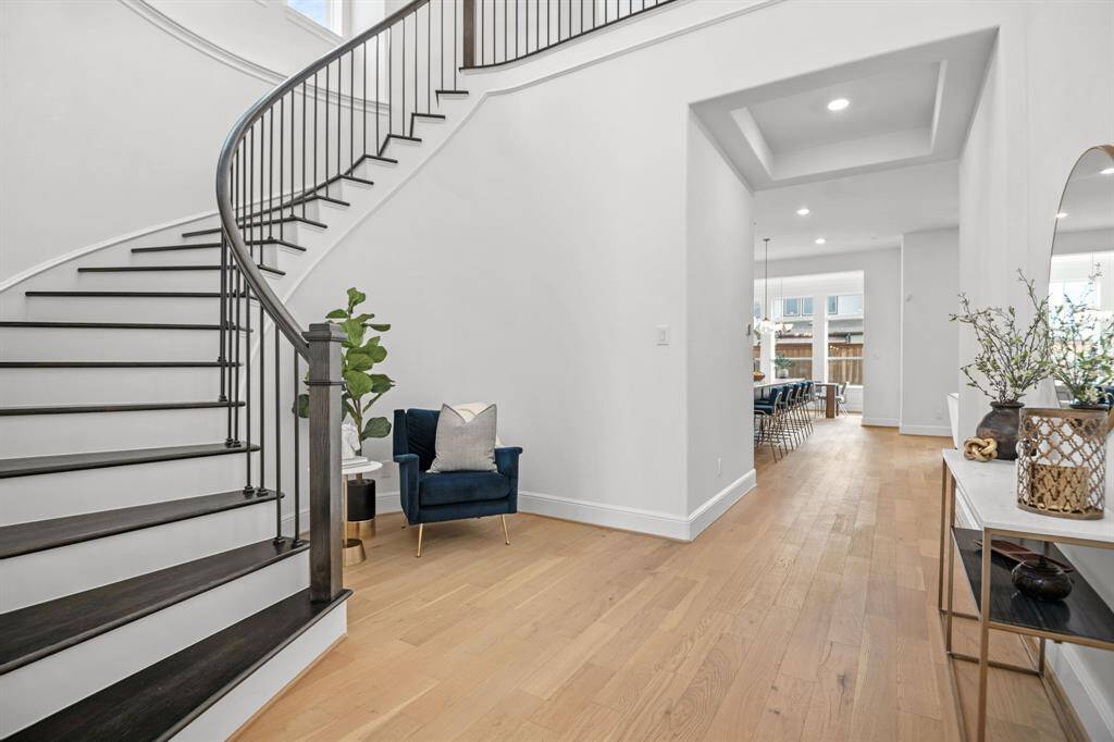 Beautiful winding staircase in foyer, featuring 20' ceilings.