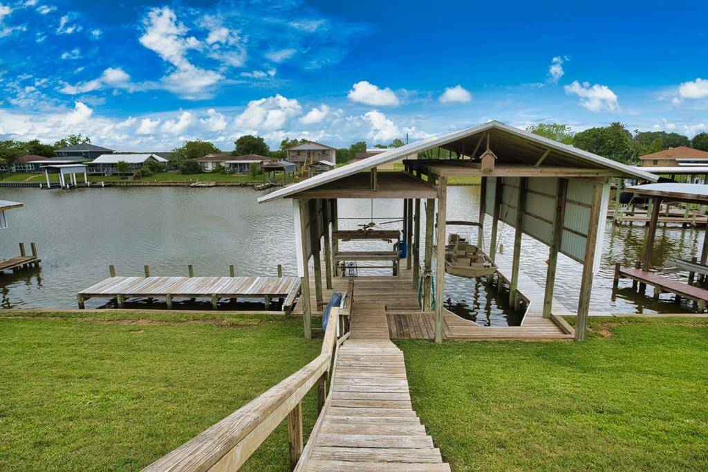 Walkway with Handrail down to the water. Come check out all amenities this dock & boat house has to offer