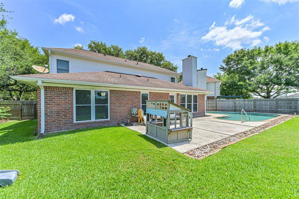 Huge backyard with tons of green space for entertaining or playing
