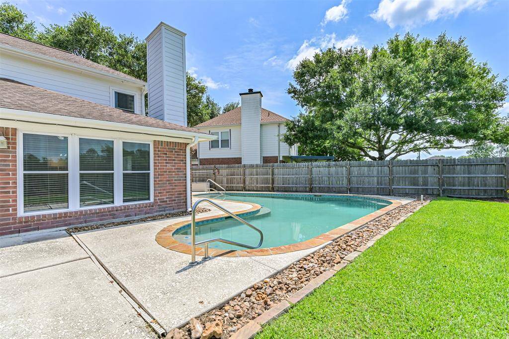 Pool located to the side of the house, cool-decking surrounding and plenty of patio area for your outdoor furniture