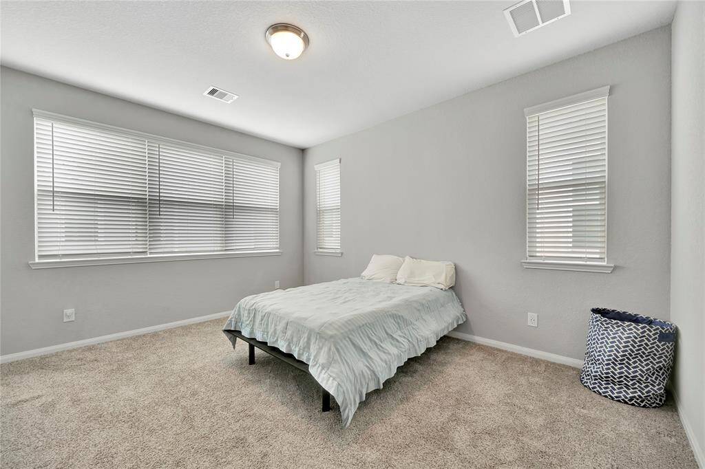 Whether you're enjoying a quiet morning with the sunlight streaming through the windows or cozying up in the evening, this bedroom offers the ideal combination of comfort, natural light, and understated elegance.
