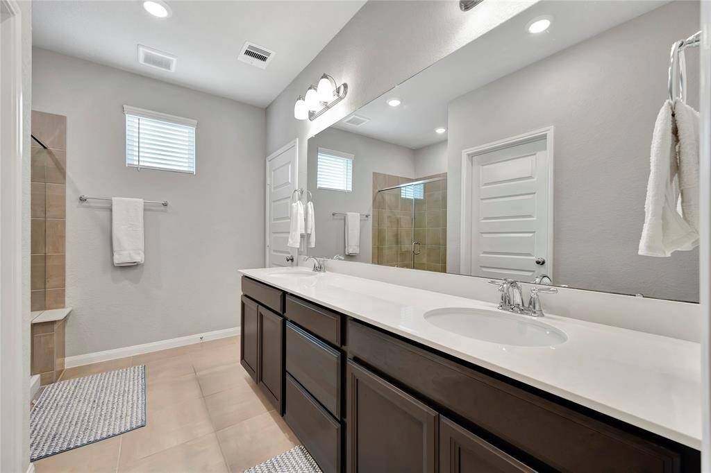 With its thoughtful design and sleek finishes, this en suite bathroom is both practical and serene, offering a private, spa-like retreat within the comfort of your own bedroom. Perfect for those seeking a stylish, functional bathroom experience.