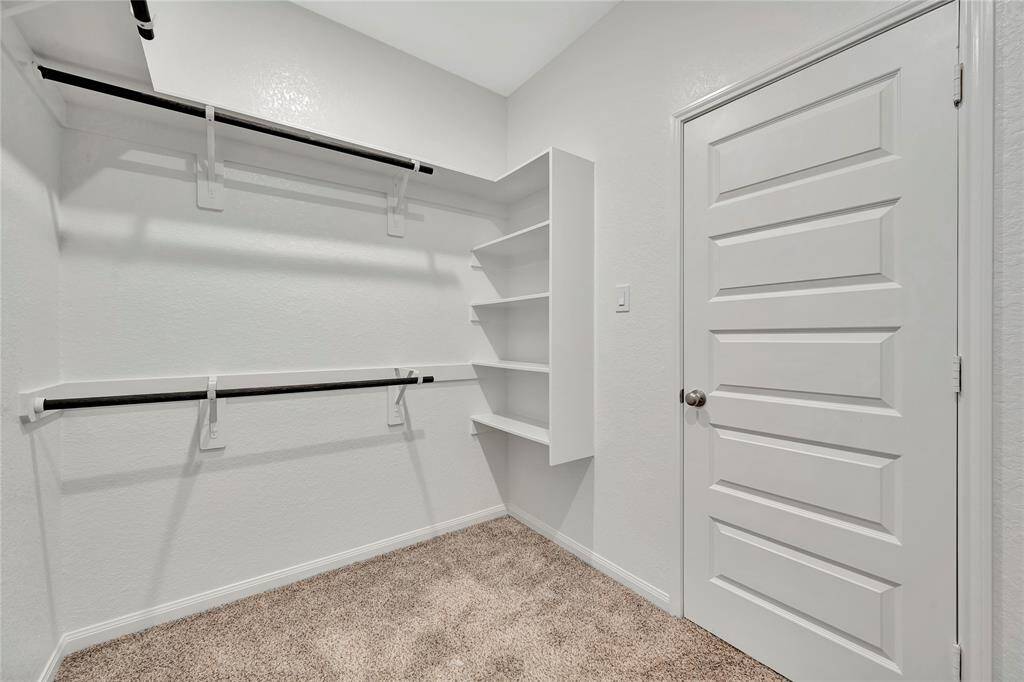 With well-planned storage options, this closet makes it easy to keep your wardrobe organized and easily accessible. Whether you're storing shoes, hanging garments, or simply admiring your collection, this walk-in closet is designed to meet all your storage needs while adding a touch of luxury to your everyday routine.