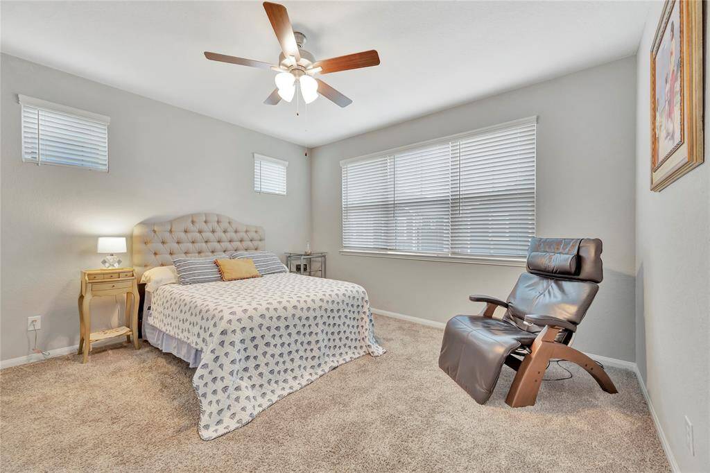This serene bedroom is designed to provide a peaceful retreat, featuring large windows that flood the space with natural light. Positioned to offer views of the surrounding landscape, the windows not only bring in abundant daylight but also create a sense of openness and connection to the outdoors. The soft, diffused light enhances the room's calming atmosphere, making it the perfect place to unwind after a long day.
