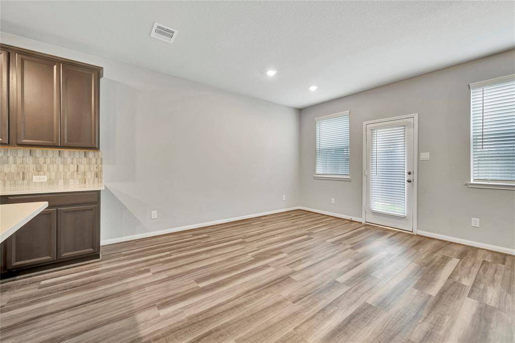 Dining area adjacent to kitchen, showcases the sturdy and attractive flooring.