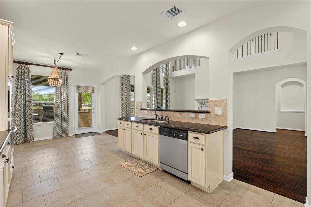 This spacious kitchen boasts an informal dining area with stunning lake views, seamless access to the living area and formal dining room, plus a conveniently tucked-away utility room.This spacious kitchen boasts an informal dining area with stunning lake views, seamless access to the living area and formal dining room, plus a conveniently tucked-away utility room.