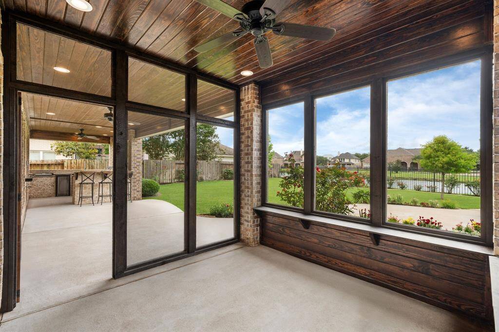 Step directly from your primary bedroom onto this private covered patio, offering stunning views of the serene lake.