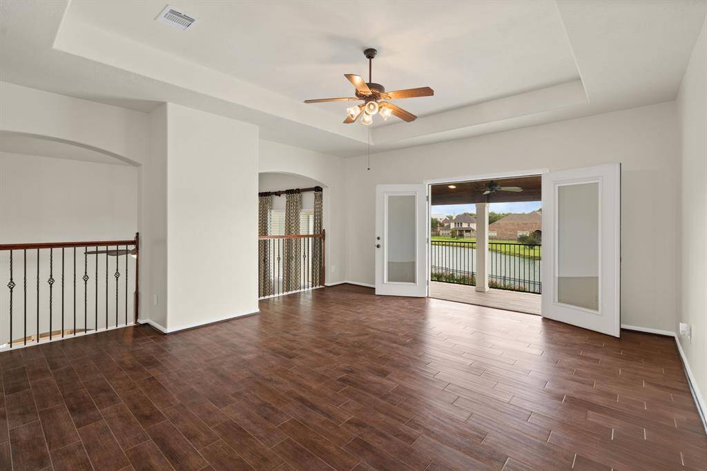 Enjoy games and entertainment in this expansive upstairs space, featuring an open view to the living below and a private covered balcony perfect for soaking in the lake scenery.