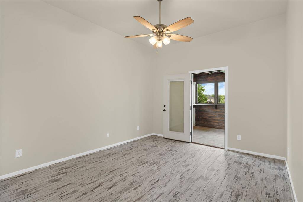 This lovely second-floor bedroom features stylish upgraded flooring, convenient access to a shared conjoining bathroom, and a private covered balcony offering beautiful views of the lake.