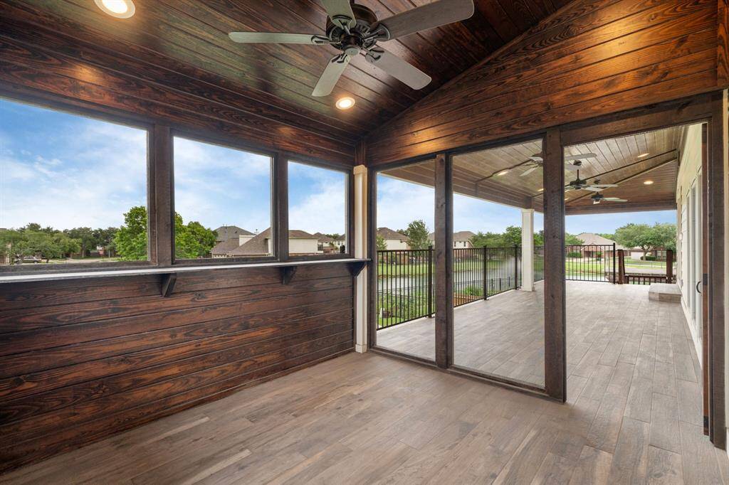 Your guests will love this private covered balcony, accessible directly from their second-floor bedroom and offering serene views of the garden and the lake.