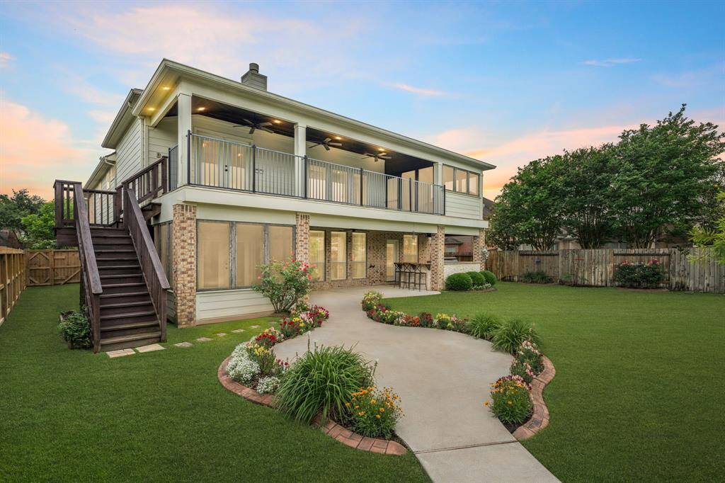 Enjoy outdoor entertaining on your partially covered second-story balcony while overlooking the beautifully maintained garden and strolling along the upgraded pathway in your private backyard.