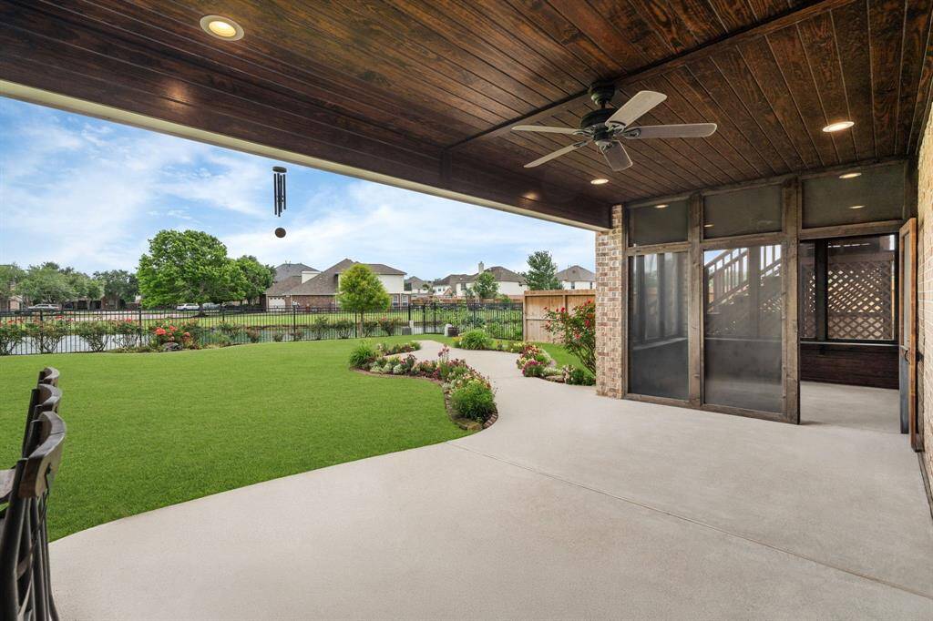 This exceptional first-floor porch serves as your gateway to outdoor living, providing stunning lake vistas and seamless access to the beautiful floral garden, the fully equipped outdoor kitchen, and the tranquility of the primary bedroom.