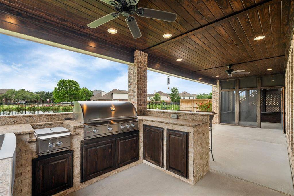 The ideal outdoor culinary space! This full kitchen includes a grill, mini fridge, built-in drink holders, a practical sink, generous storage, and more for effortless outdoor cooking and enjoyment.