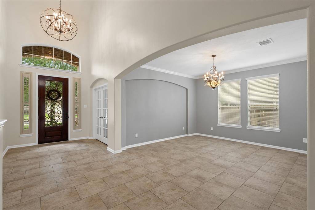 Host memorable gatherings in this elegant formal dining room, featuring an original chandelier, abundant natural light, and seamless access to the kitchen.