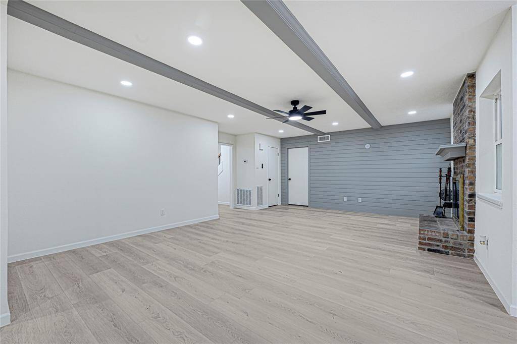 Spacious Living Room with Shiplap Accent Wall and Gas Fireplace
