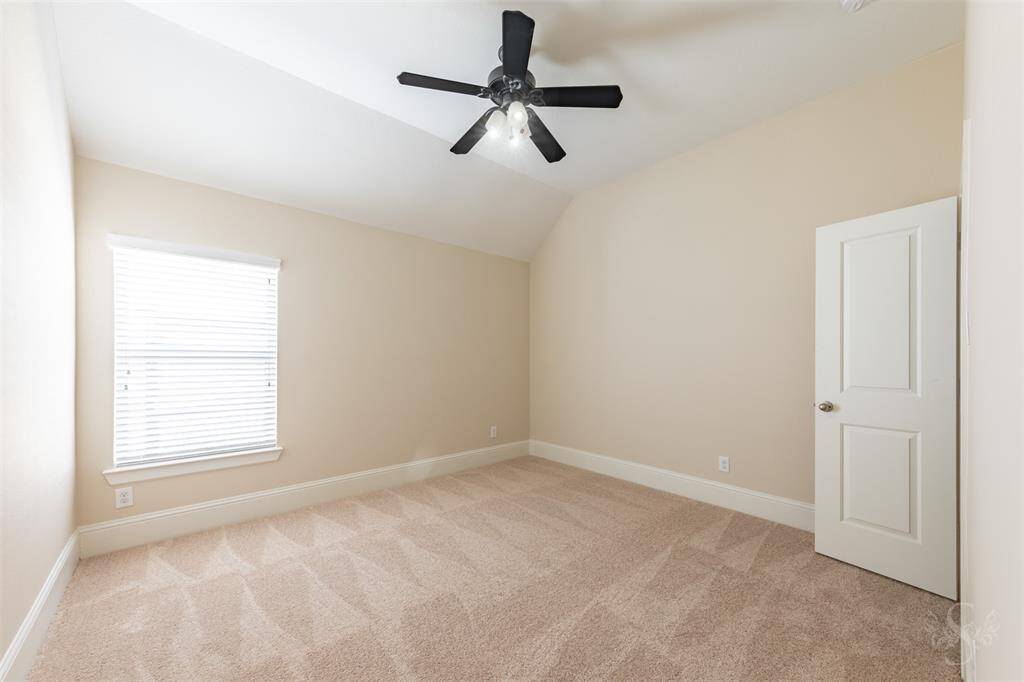Secondary bedroom providing the space you need for a large bed and any additional furnishings needed including student desks and bookcases. Featuring a high angled ceiling, plush carpet for comfort and window with blinds.