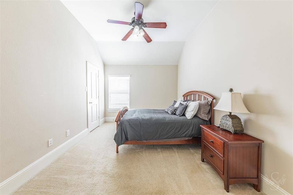Secondary bedroom providing the space you need for a large bed and any additional furnishings needed including student desks and bookcases. Featuring a high angled ceiling, plush carpet for comfort and window with blinds.