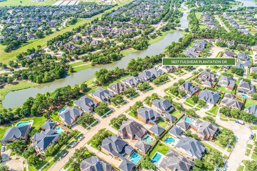 Nestled on a peaceful lakefront lot, this David Weekly home offers picturesque views and direct access to scenic walking trails in Cross Creek Ranch. The aerial perspective showcases the home’s prime location near the water and beautifully landscaped neighborhood.