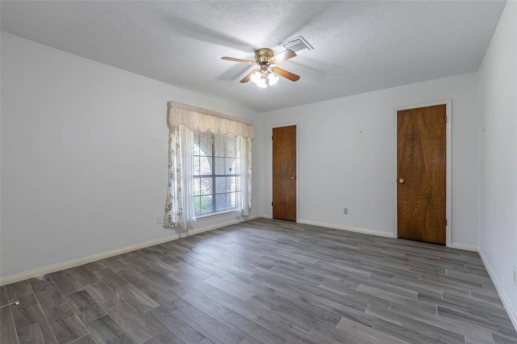 Bright and inviting with fresh paint, new flooring, and updated blinds—ideal for guests, kids, or a home office.