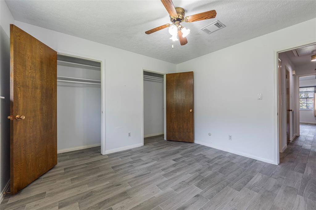 Both secondary bedrooms feature new flooring, fresh paint, and new blinds, perfect for family, guests, or a home office setup.