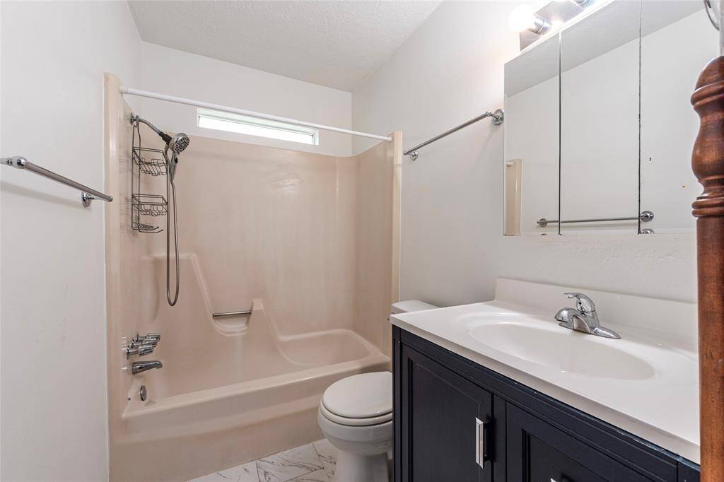 The updated hall bath includes new flooring, refreshed plumbing, and a classic tub/shower combo—ideal for guests or kids.