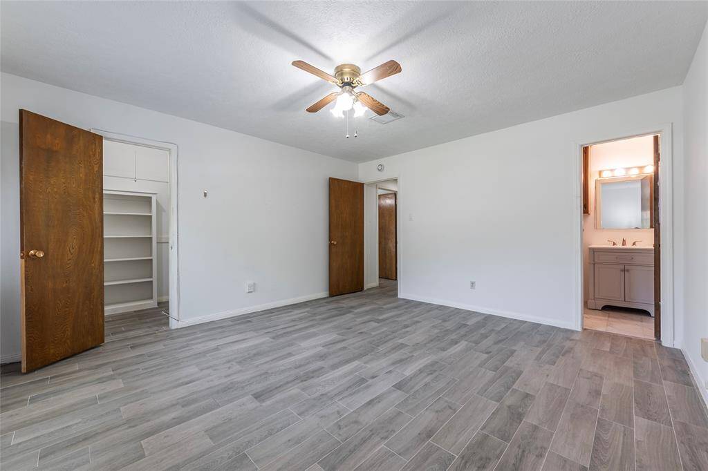 Primary suite offers a large walk-in closet and a newly renovated ensuite complete with a modern shower, vanity, and updated plumbing.