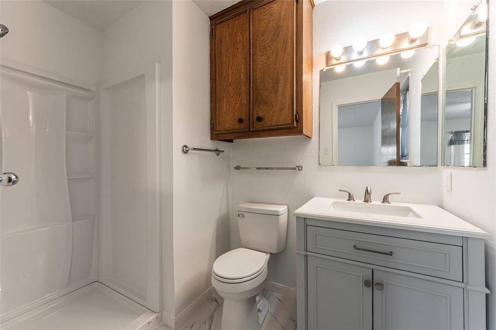 Fully renovated en-suite bath with sleek new shower, vanity, and updated fixtures.