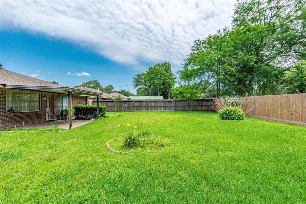 This large backyard offers a peaceful escape with endless possibilities, all framed by a brand new fence