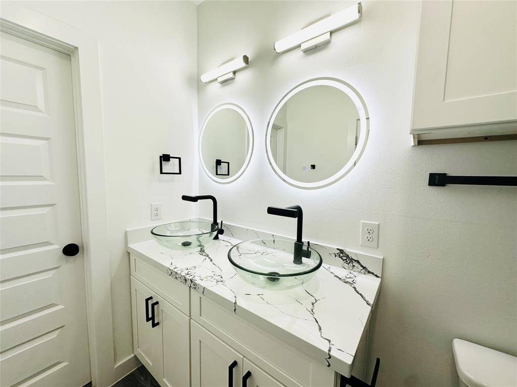 Wake up to a magazine worthy bathroom every morning featuring beautiful quartz countertops, LED backlit multi function mirrors, glass vanity vessel sinks, double stacked solid wood head knocker cabinets w/ soft close doors over the toilet, spa grade faucets and hardware plus more. Buyer can choose between brushed Nickel or Matte Black faucets and hardware.